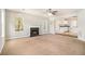 Spacious living room with fireplace, ceiling fan, and open access to kitchen area at 498 Pecan Wood Cir, Fairburn, GA 30213