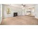 Spacious living room with a cozy fireplace and seamless transition to the modern kitchen at 498 Pecan Wood Cir, Fairburn, GA 30213