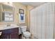 Cozy bathroom with a vanity, toilet, and bathtub with shower and white and blue curtain at 57 Cedarcrest Village Ln, Acworth, GA 30101
