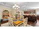 Charming dining area featuring an elegant chandelier, hardwood flooring, and access to the kitchen at 57 Cedarcrest Village Ln, Acworth, GA 30101