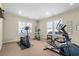 Well-lit exercise room with an array of equipment and neutral carpeting, ideal for a home gym at 57 Cedarcrest Village Ln, Acworth, GA 30101