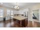 Modern kitchen boasts white cabinets, stainless steel appliances, granite countertops and a large island with dark wood base at 57 Cedarcrest Village Ln, Acworth, GA 30101