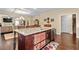Spacious kitchen featuring an island with seating, stainless steel appliances, hardwood floors and an open layout at 57 Cedarcrest Village Ln, Acworth, GA 30101