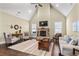Comfortable living room featuring a stone fireplace, dark hardwood floors, and neutral-toned walls and furnishings at 57 Cedarcrest Village Ln, Acworth, GA 30101