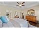 Spacious main bedroom featuring a tray ceiling, ceiling fan, and wood dresser at 57 Cedarcrest Village Ln, Acworth, GA 30101