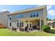Large backyard with a covered patio, firepit, and outdoor seating creating an inviting entertaining space at 7130 Ansley Park Way, Cumming, GA 30028