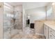 Bathroom boasting a glass shower with tile and a double vanity with white accents at 7130 Ansley Park Way, Cumming, GA 30028