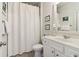 This bathroom features a white vanity, white shower curtain, neutral paint, and tile floors at 7130 Ansley Park Way, Cumming, GA 30028