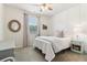 The bedroom features a ceiling fan, neutral paint, wainscoting, and carpet at 7130 Ansley Park Way, Cumming, GA 30028