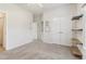 Empty bedroom with floating shelves and access to closet and hallway at 7130 Ansley Park Way, Cumming, GA 30028