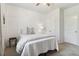 This bedroom boasts neutral paint, wainscoting, a ceiling fan, and carpet at 7130 Ansley Park Way, Cumming, GA 30028