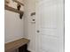 The entryway features a bench, coat hooks, a key holder, and a white door at 7130 Ansley Park Way, Cumming, GA 30028