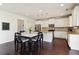 Eat-in kitchen with white cabinets, granite counters, stainless appliances, and modern pendant lighting at 7130 Ansley Park Way, Cumming, GA 30028