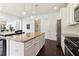 Kitchen featuring an island with granite counters and stainless appliances at 7130 Ansley Park Way, Cumming, GA 30028