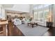 Bright and airy living room with large windows, hardwood floors, and an open layout at 7130 Ansley Park Way, Cumming, GA 30028