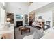 Bright living room featuring a fireplace, built-in shelves, and an open concept design at 7130 Ansley Park Way, Cumming, GA 30028