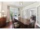 The office boasts wood floors, a decorative light fixture, and double doors leading to the dining room at 7130 Ansley Park Way, Cumming, GA 30028