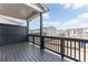 Back porch featuring black railing, black privacy wall, and a view of neighboring townhomes at 1162 Buice Lake Pkwy, Acworth, GA 30102