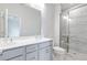 Bathroom featuring dual sinks, shower, tile, mirror, and granite countertops at 1162 Buice Lake Pkwy, Acworth, GA 30102