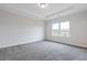 Spacious bedroom with tray ceilings, gray carpet, two windows, and view of neighborhood at 1162 Buice Lake Pkwy, Acworth, GA 30102