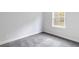 A bedroom that features new carpet and a window overlooking the yard at 1162 Buice Lake Pkwy, Acworth, GA 30102