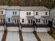 Rear view of new townhomes with individual garages and covered porches at 1162 Buice Lake Pkwy, Acworth, GA 30102