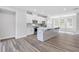 Open-concept kitchen with hardwood floors, island, and stainless steel appliances at 1162 Buice Lake Pkwy, Acworth, GA 30102