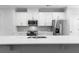 Well-lit kitchen with white countertops, island sink, and stainless steel appliances at 1162 Buice Lake Pkwy, Acworth, GA 30102