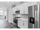 Modern kitchen with stainless steel appliances, light gray subway tile backsplash, and white cabinets at 1162 Buice Lake Pkwy, Acworth, GA 30102