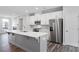Spacious kitchen with hardwood floors, white cabinets, and stainless steel appliances at 1162 Buice Lake Pkwy, Acworth, GA 30102