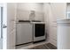 Convenient laundry room featuring a new washer and dryer set with a storage shelf above at 1162 Buice Lake Pkwy, Acworth, GA 30102