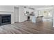 Open-concept living space featuring a kitchen, fireplace, and hardwood floors at 1162 Buice Lake Pkwy, Acworth, GA 30102