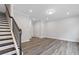 Spacious living room featuring hardwood floors, a staircase, and neutral paint at 1162 Buice Lake Pkwy, Acworth, GA 30102