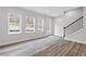Bright living room with hardwood floors, large windows, and access to outdoor space at 1162 Buice Lake Pkwy, Acworth, GA 30102