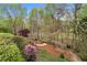 Landscaped backyard with mature trees, shrubs, and flowers offering privacy and a tranquil setting at 3520 Millwater Xing, Dacula, GA 30019
