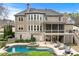 Backyard features a private pool, jacuzzi, and screened porch, ideal for entertaining and relaxing in style at 3520 Millwater Xing, Dacula, GA 30019