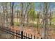 Backyard with mature trees and black fencing offering privacy and a serene outdoor living space at 3520 Millwater Xing, Dacula, GA 30019