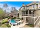 Beautiful backyard with pool, hot tub, lounge chairs and covered porch perfect for relaxation and entertaining at 3520 Millwater Xing, Dacula, GA 30019