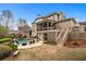 Spacious backyard boasts a large pool, spa, deck, patio area, and lush landscaping at 3520 Millwater Xing, Dacula, GA 30019