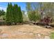 Backyard features lush greenery, mature trees, a charming bench, and stone path at 3520 Millwater Xing, Dacula, GA 30019