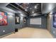 Home theater room in a finished basement, complete with carpet, movie posters, and a projector at 3520 Millwater Xing, Dacula, GA 30019