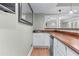 Basement wet bar with white cabinetry and a wood countertop at 3520 Millwater Xing, Dacula, GA 30019