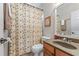 Cozy bathroom with vanity sink, floral shower curtain, and great lighting at 3520 Millwater Xing, Dacula, GA 30019