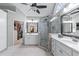 Luxurious bathroom with double sinks, a glass shower, and walk-in closet access at 3520 Millwater Xing, Dacula, GA 30019