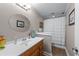 Bathroom features updated vanity, modern fixtures, a large mirror, and a shower with curtain at 3520 Millwater Xing, Dacula, GA 30019