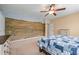 Bedroom showcasing a mural, a ceiling fan, a comfortable bed, and a dresser, great for a peaceful retreat at 3520 Millwater Xing, Dacula, GA 30019