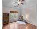 Cozy bedroom with hardwood floors, bright window and sitting chair at 3520 Millwater Xing, Dacula, GA 30019