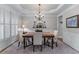 Elegant dining room featuring wainscoting, tray ceiling, and plantation shutters, perfect for formal gatherings at 3520 Millwater Xing, Dacula, GA 30019