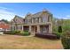Charming two-story home with a manicured lawn and inviting front porch, perfect for relaxing and enjoying the outdoors at 3520 Millwater Xing, Dacula, GA 30019