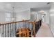 Hallway with staircase, iron railing and beautiful light fixture at 3520 Millwater Xing, Dacula, GA 30019